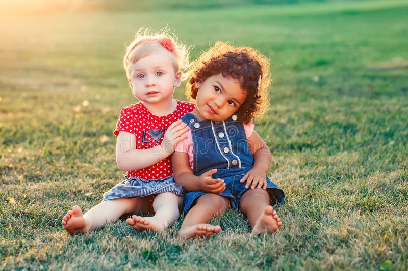 white-caucasian-latin-hispanic-babies-hugging-outside-park-group-portrait-two-cute-adorable-girls-toddlers-children-124054513 - Shop Baby Boutiques 